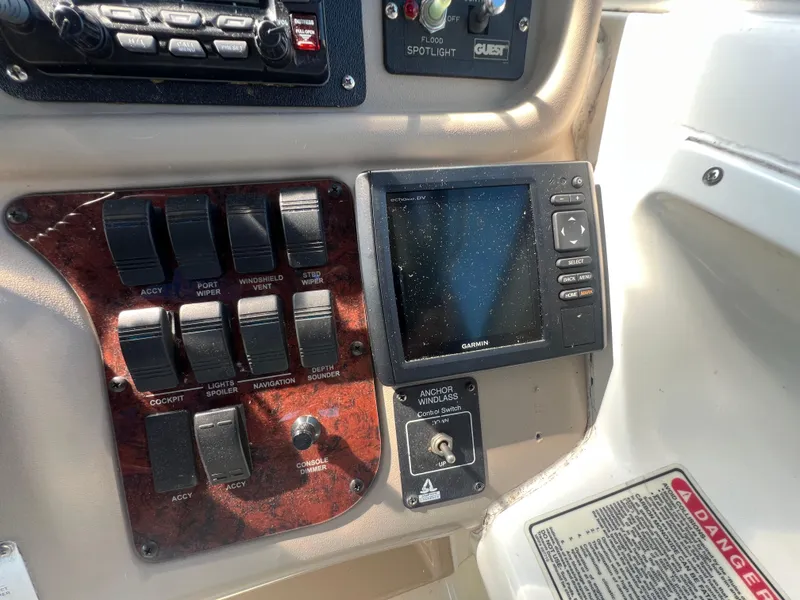 Slide: The Image of Control panel of a 1998 Sea Ray 290 Sundancer boat with switches and Garmin display. - 11