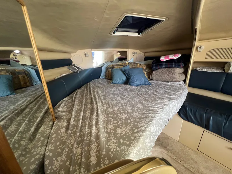 Slide: The Image of Interior of 1998 Sea Ray 290 Sundancer with blue seating and storage cabinets. - 14