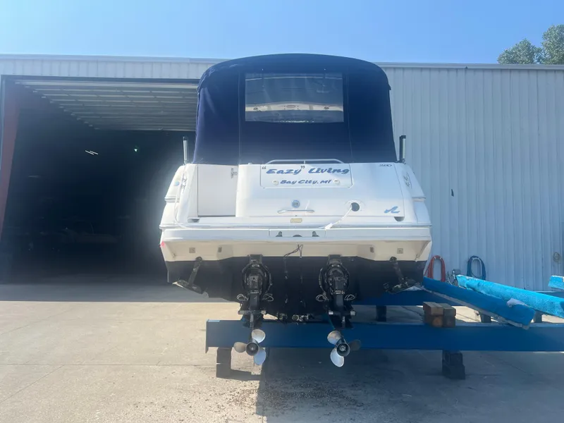 Slide: The Image of 1998 Sea Ray 290 Sundancer cabin interior with bed, seating, and dehumidifier. - 3