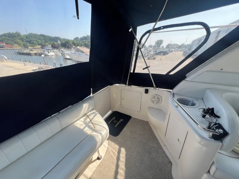 Slide: The Image of 1998 Sea Ray 290 Sundancer bathroom with sink, toilet, and porthole window. - 4