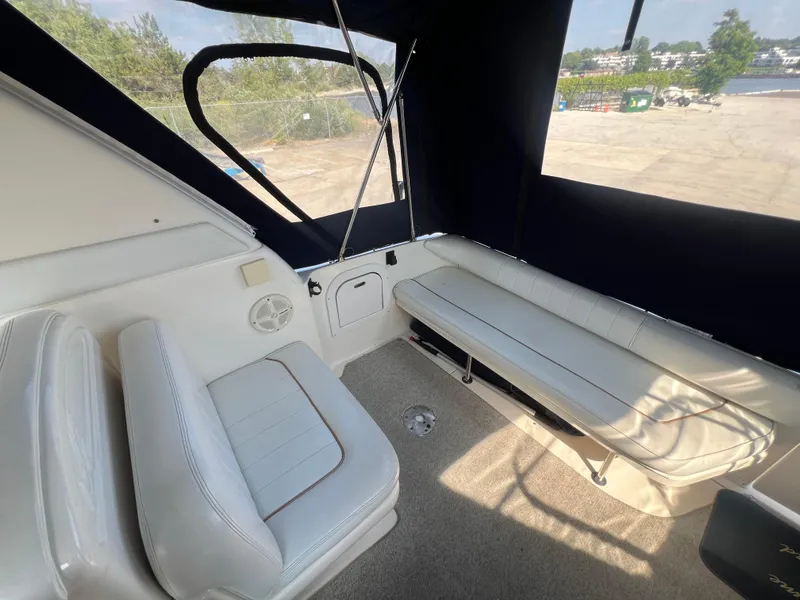 Slide: The Image of 1998 Sea Ray 290 Sundancer boat on dry dock under clear blue sky. - 5