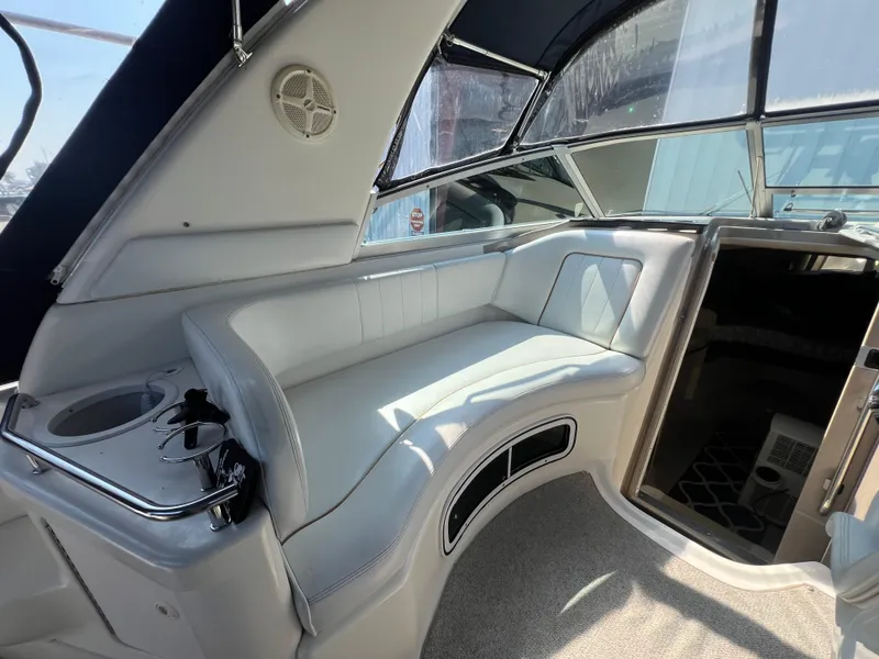 Slide: The Image of 1998 Sea Ray 290 Sundancer interior with white seating and carpeted floor. - 8
