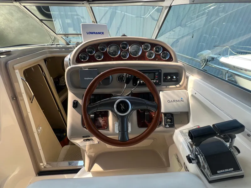Slide: The Image of 1998 Sea Ray 290 Sundancer interior with white seating and cup holders. - 9