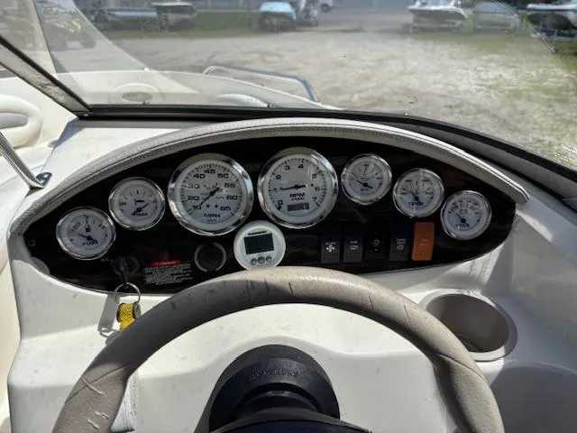 Slide: The Image of Dashboard of a 2006 Stingray 185 LS/LX boat with gauges and controls. - 12