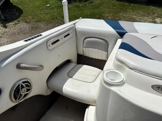 Slide: The Image of 2006 Stingray 185 LS/LX boat interior with white and blue seating, speaker, and cup holder. - 16