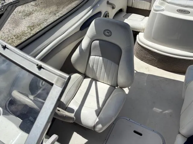 Slide: The Image of 2006 Stingray 185 LS/LX boat interior with white seating and steering area. - 9