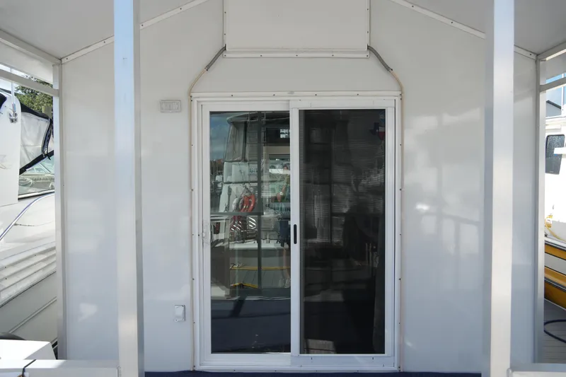 Slide: The Image of 2024 Catamaran Aqua Lodge with sliding glass door, docked at marina. - 10