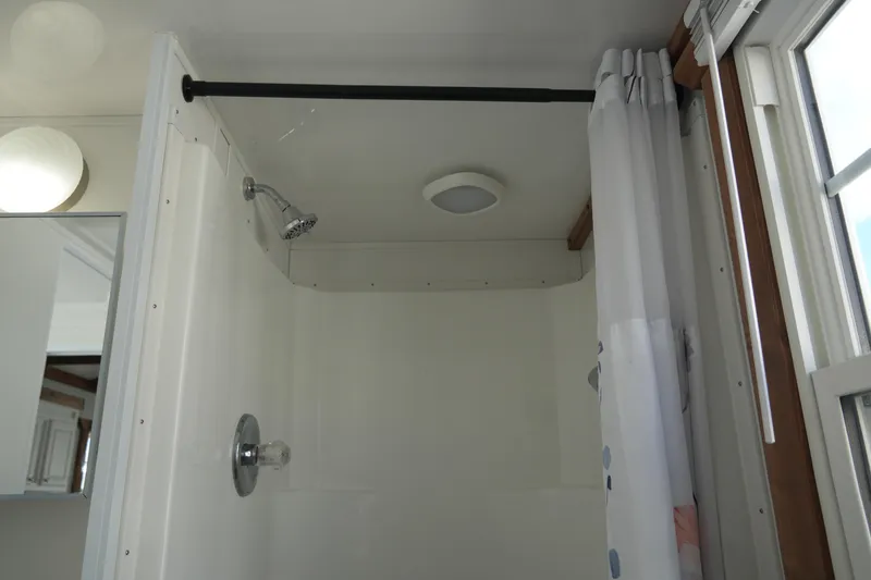 Slide: The Image of Shower area in 2024 Catamaran Aqua Lodge with curtain and modern fixtures. - 25