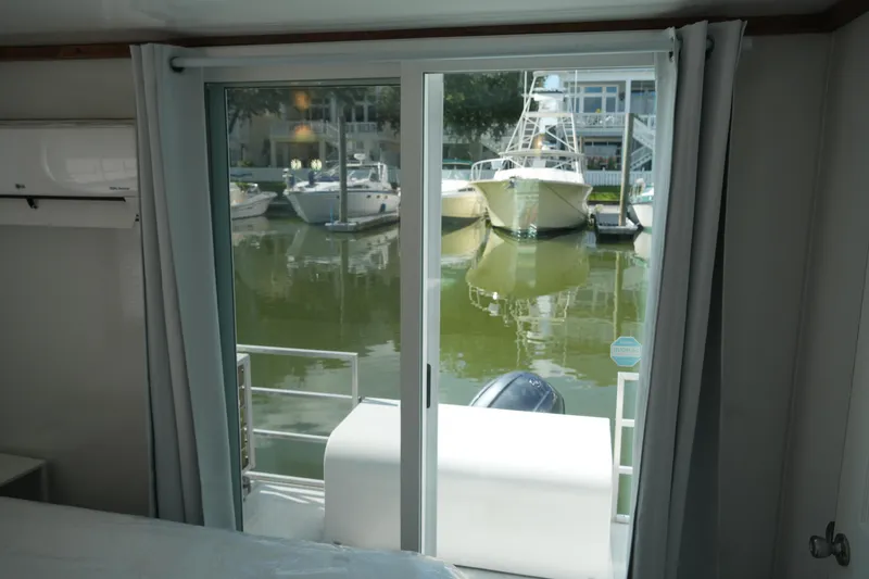 Slide: The Image of Interior view of 2024 Catamaran Aqua Lodge with marina through sliding glass doors. - 28