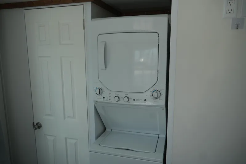 Slide: The Image of Stacked washer and dryer in 2024 Catamaran Aqua Lodge interior. - 35