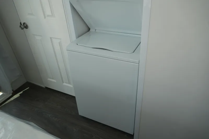 Slide: The Image of Washing machine in 2024 Catamaran Aqua Lodge, compact laundry area. - 36