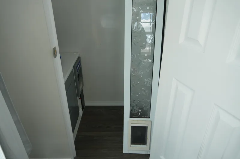 Slide: The Image of 2024 Catamaran Aqua Lodge interior with modern design, featuring a decorative glass panel and dark flooring. - 38