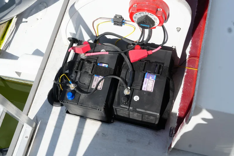 Slide: The Image of 2024 Catamaran Aqua Lodge battery compartment with dual batteries and wiring. - 5