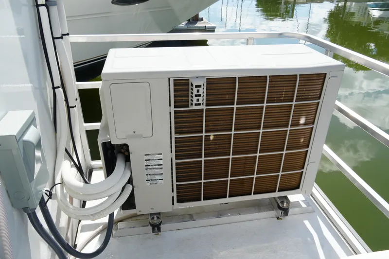 Slide: The Image of Outdoor air conditioning unit on 2024 Catamaran Aqua Lodge, docked by water. - 6