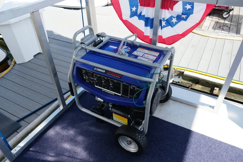 Slide: The Image of Portable Yamaha generator on Catamaran Aqua Lodge, 2024 model, with patriotic decor. - 9