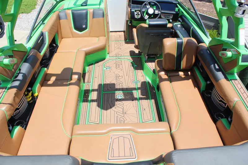 Slide: The Image of 2017 Nautique Super Air Nautique G23 interior with green and tan seating, modern design. - 10