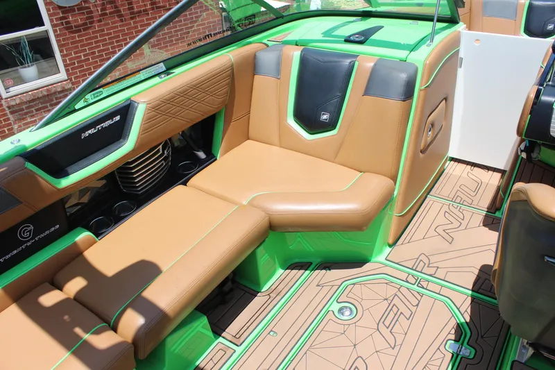 Slide: The Image of 2017 Nautique Super Air Nautique G23 interior with tan and green seating. - 12