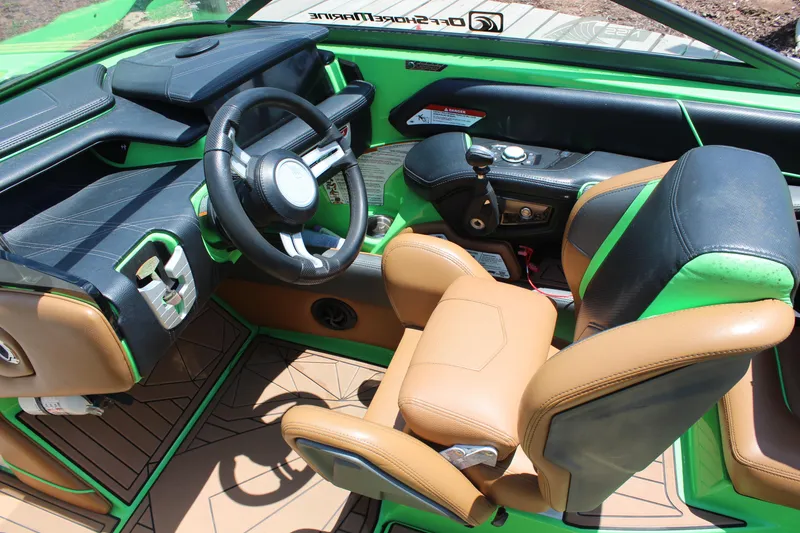 Slide: The Image of Interior of 2017 Nautique Super Air Nautique G23 boat with green and tan seating. - 13