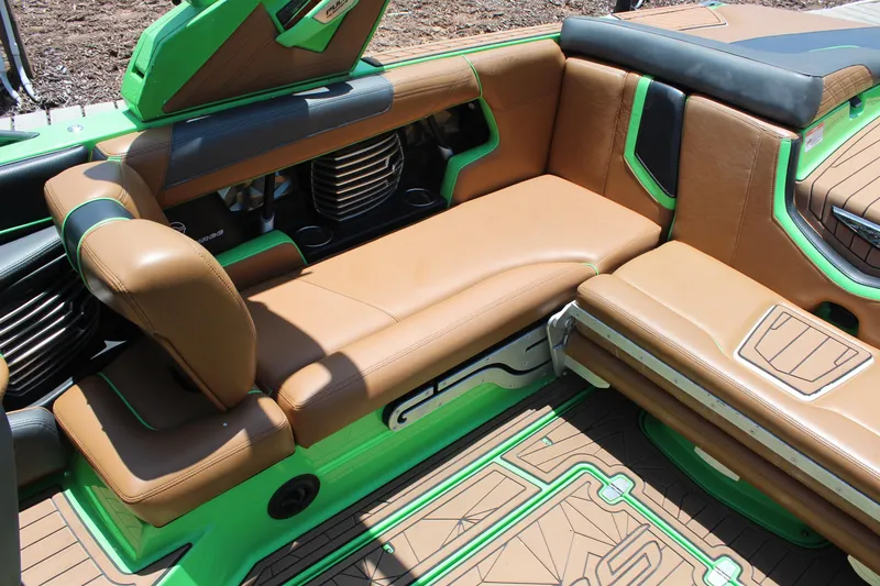 Slide: The Image of 2017 Nautique Super Air Nautique G23 interior with brown and green seating. - 14