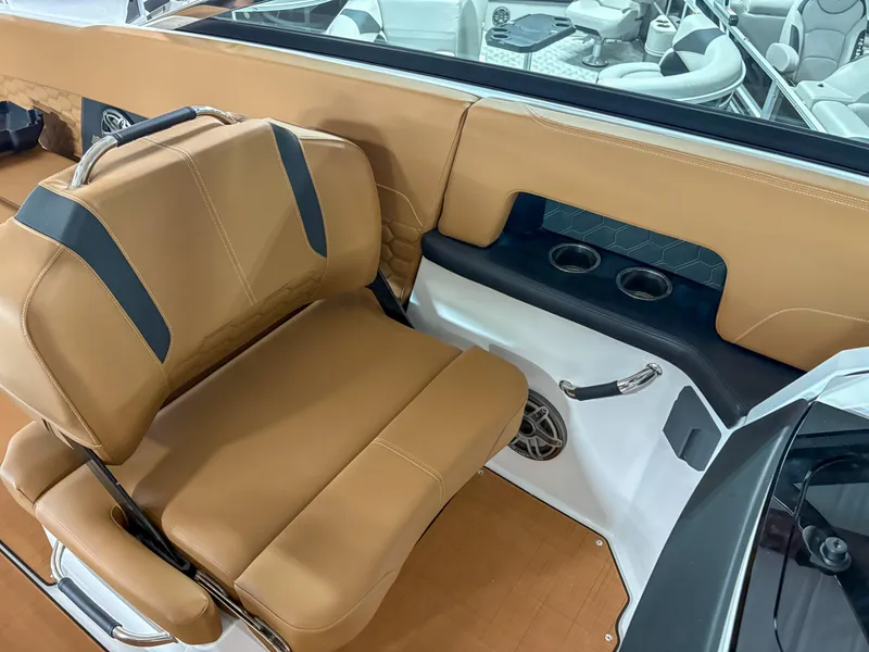 Slide: The Image of 2026 Four Winns H9 boat interior with tan seating and cup holders. - 10