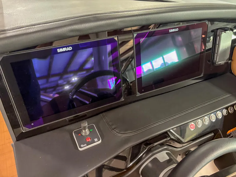 Slide: The Image of Dashboard of 2026 Four Winns H9 boat with dual Simrad displays and control panel. - 12