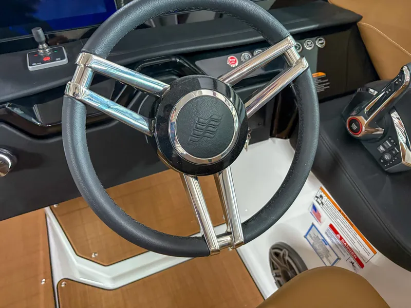 Slide: The Image of Steering wheel of 2026 Four Winns H9 boat, featuring sleek design and modern controls. - 13