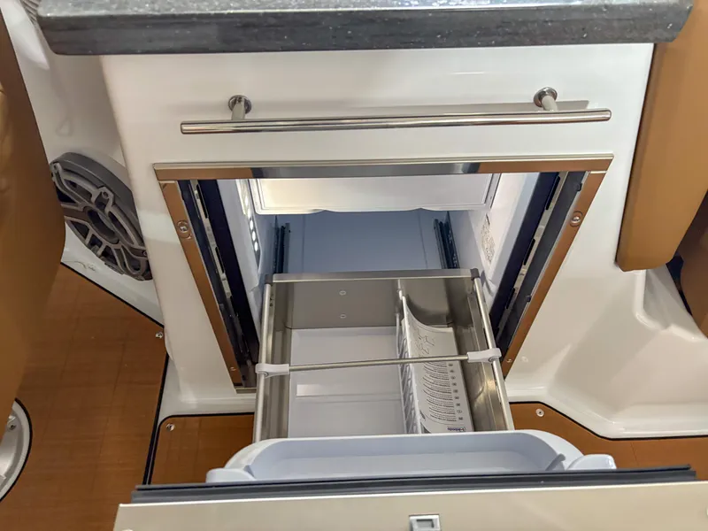 Slide: The Image of Open drawer refrigerator in 2026 Four Winns H9 boat interior. - 16
