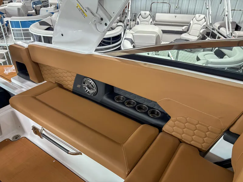 Slide: The Image of Luxurious interior of 2026 Four Winns H9 boat with tan seating and cup holders. - 19