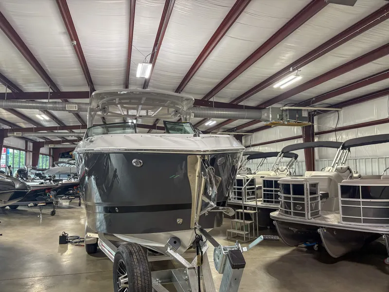 Slide: The Image of 2026 Four Winns H9 boat in a showroom, surrounded by other boats. - 3