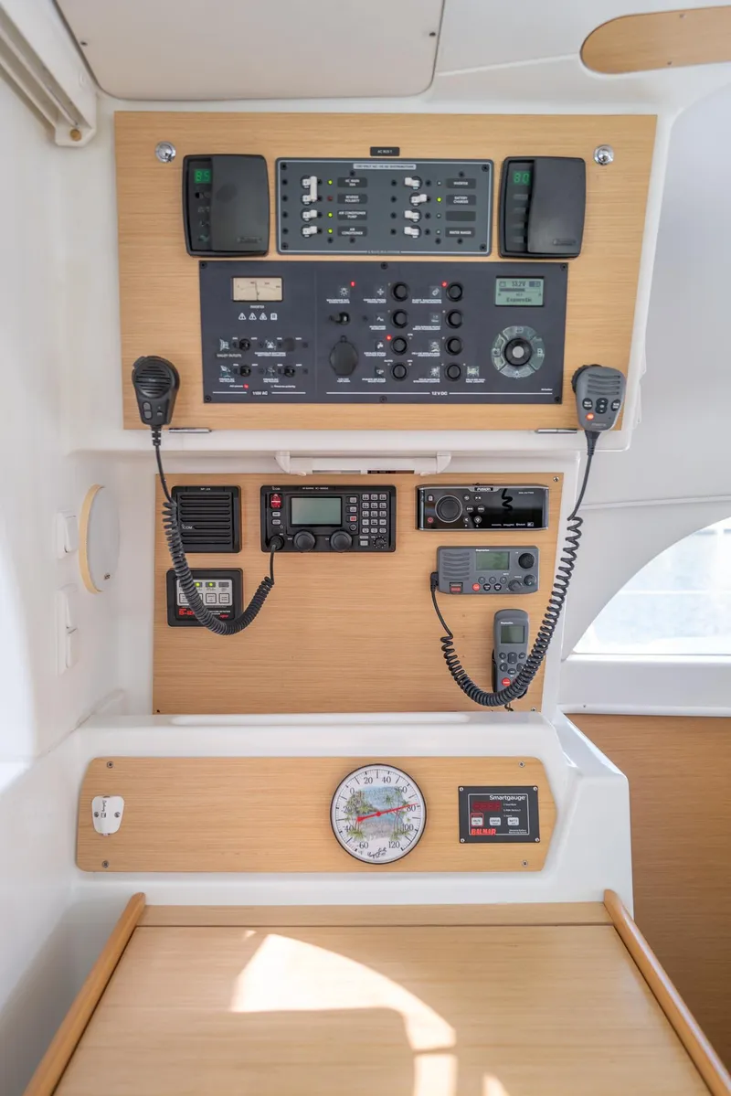 Slide: The Image of Control panel of a 2011 Lagoon 380 S2 catamaran, featuring navigation and communication equipment. - 10
