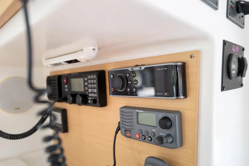 Slide: The Image of Control panel of a 2011 Lagoon 380 S2 yacht with communication and audio equipment. - 12