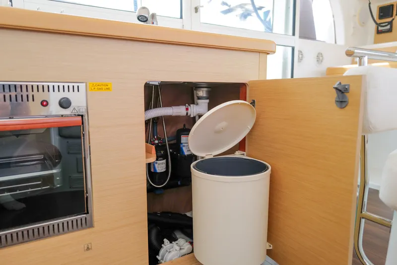 Slide: The Image of Interior of 2011 Lagoon 380 S2 yacht showing kitchen storage and appliances. - 14