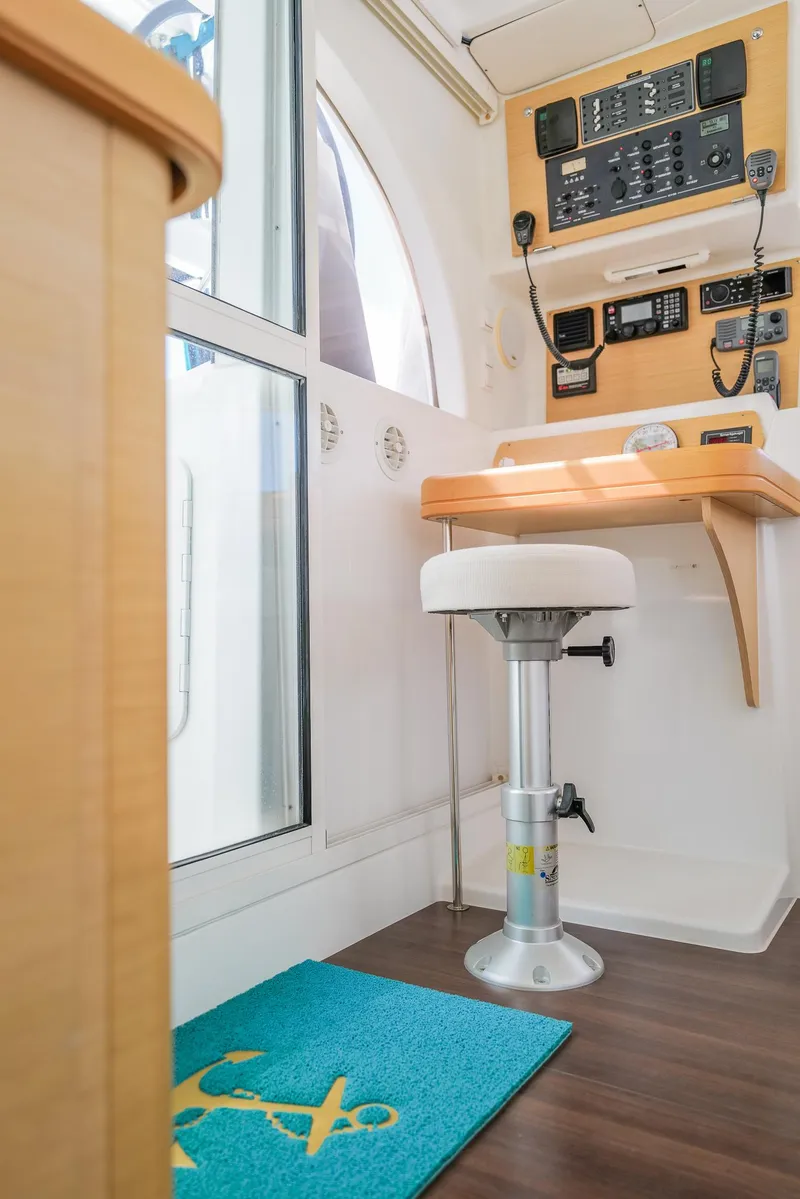 Slide: The Image of Interior of 2011 Lagoon 380 S2 yacht with navigation panel and stool. - 15