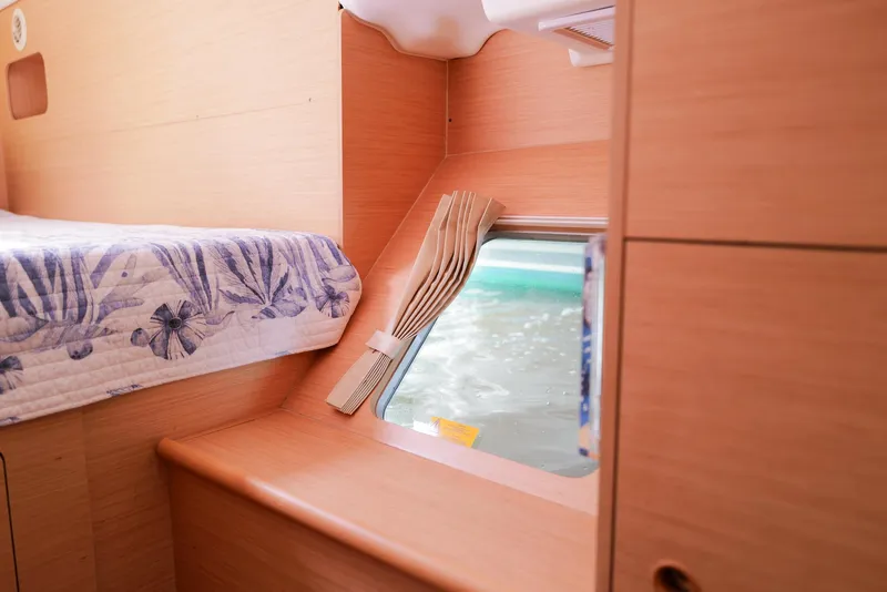 Slide: The Image of Interior of 2011 Lagoon 380 S2 yacht cabin with bed and window view. - 20