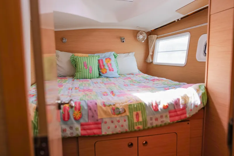 Slide: The Image of Cozy bedroom in 2011 Lagoon 380 S2 catamaran with colorful bedding and natural light. - 26