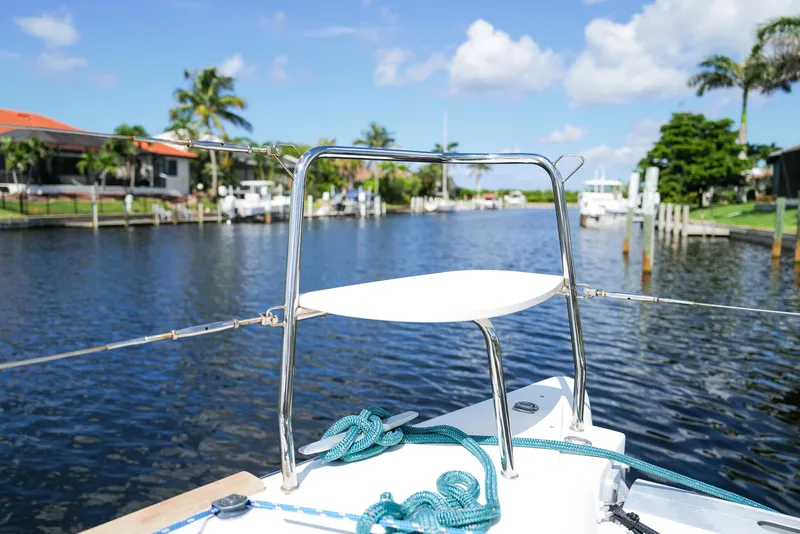 Slide: The Image of Bow of 2011 Lagoon 380 S2 catamaran on a sunny day, docked in a scenic canal. - 35