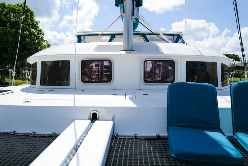 Slide: The Image of 2011 Lagoon 380 S2 catamaran with blue seating, sunny day, clear sky. - 37