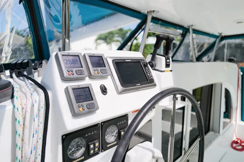 Slide: The Image of Cockpit of 2011 Lagoon 380 S2 catamaran with navigation instruments and steering wheel. - 4