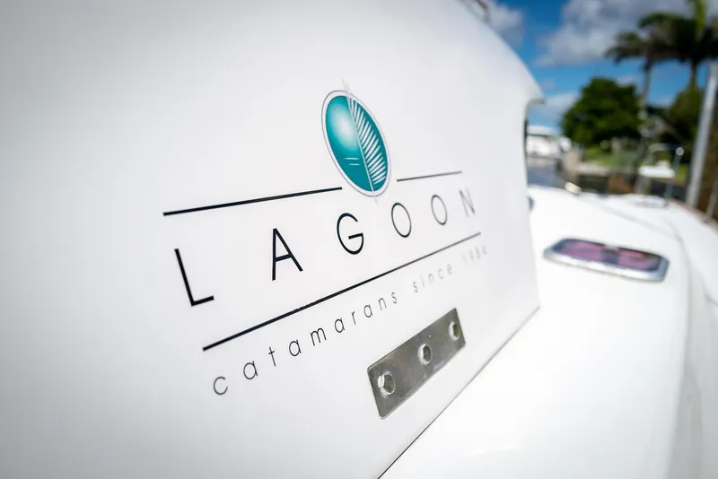 Slide: The Image of Lagoon 380 S2 catamaran logo on white surface, 2011 model, sunny day background. - 42