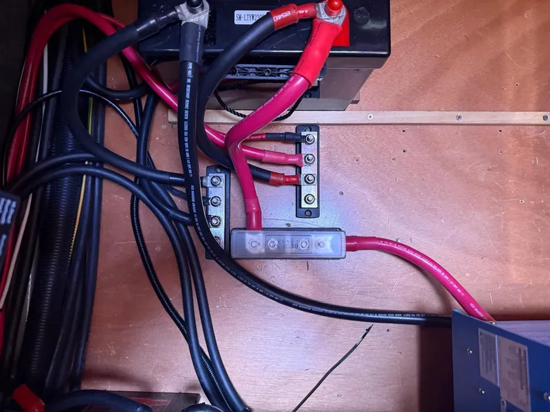 Slide: The Image of Electrical wiring setup in a 2011 Lagoon 380 S2 boat, featuring cables and connectors. - 43