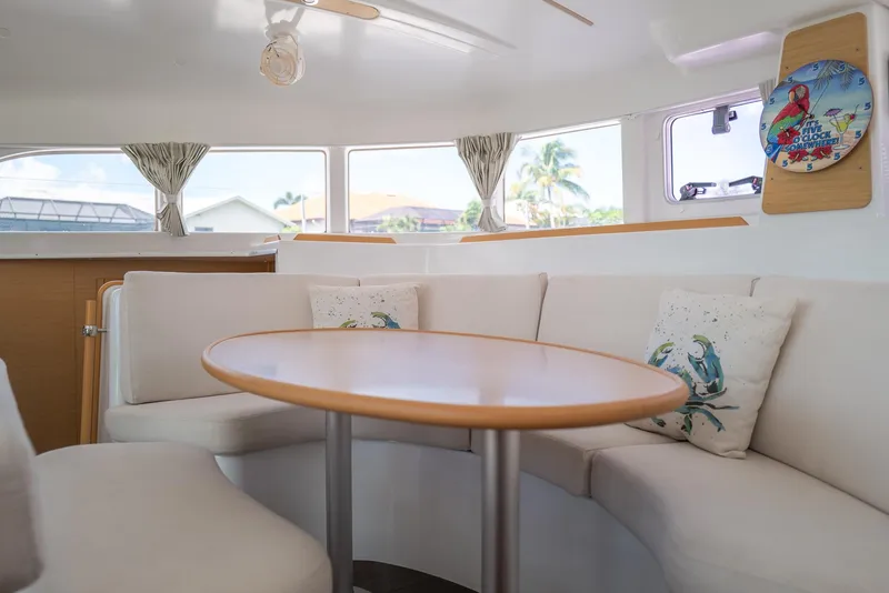Slide: The Image of Interior of 2011 Lagoon 380 S2 catamaran with cozy seating and decorative pillows. - 6