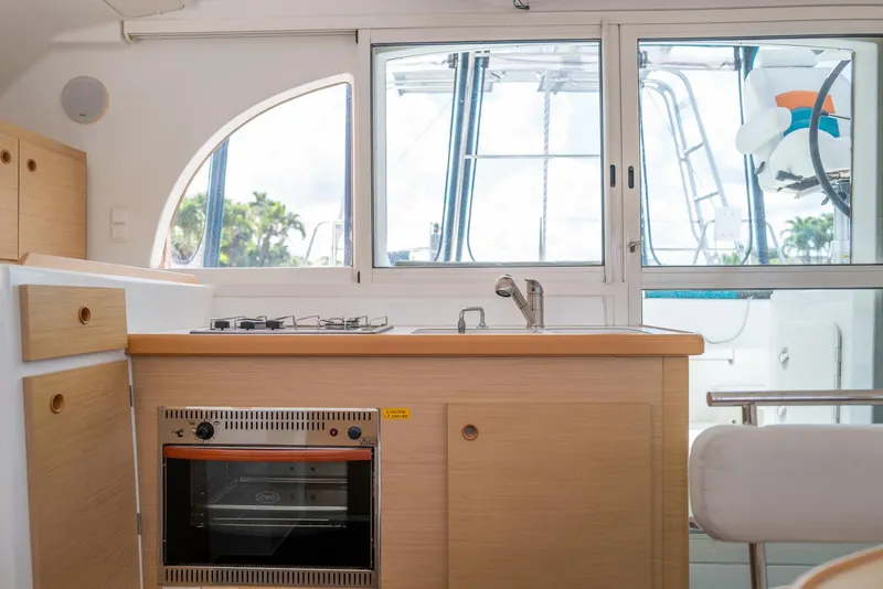 Slide: The Image of Interior of 2011 Lagoon 380 S2 yacht kitchen with stove, oven, and sink. - 9