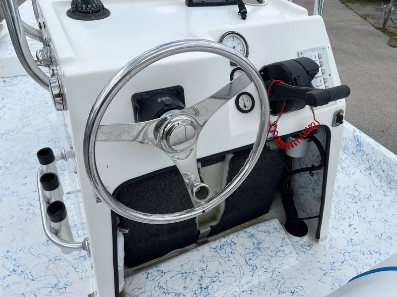 Slide: The Image of 2007 Shallow Stalker V20 boat console with steering wheel and controls. - 10
