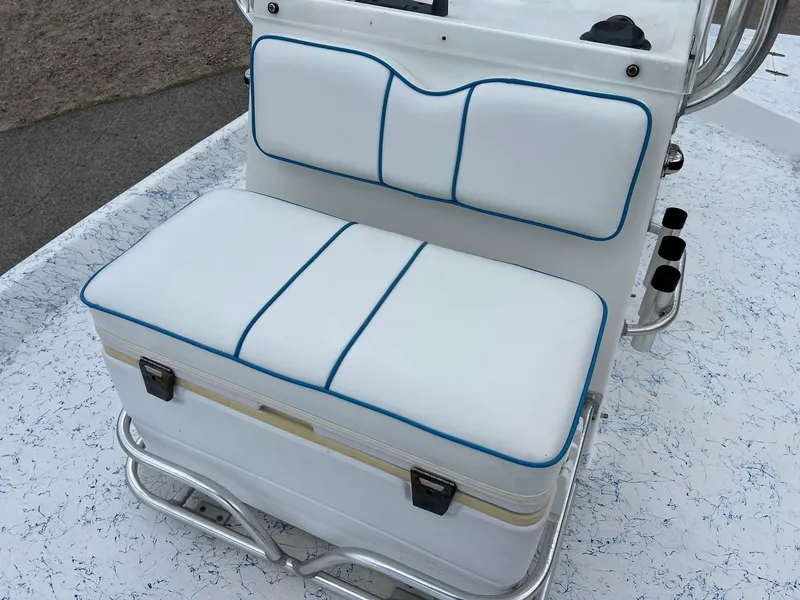 Slide: The Image of White cushioned seat on 2007 Shallow Stalker V20 boat, featuring blue trim and storage compartment. - 16