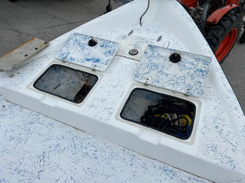Slide: The Image of 2007 Shallow Stalker V20 boat deck with open storage compartments and blue speckled design. - 17