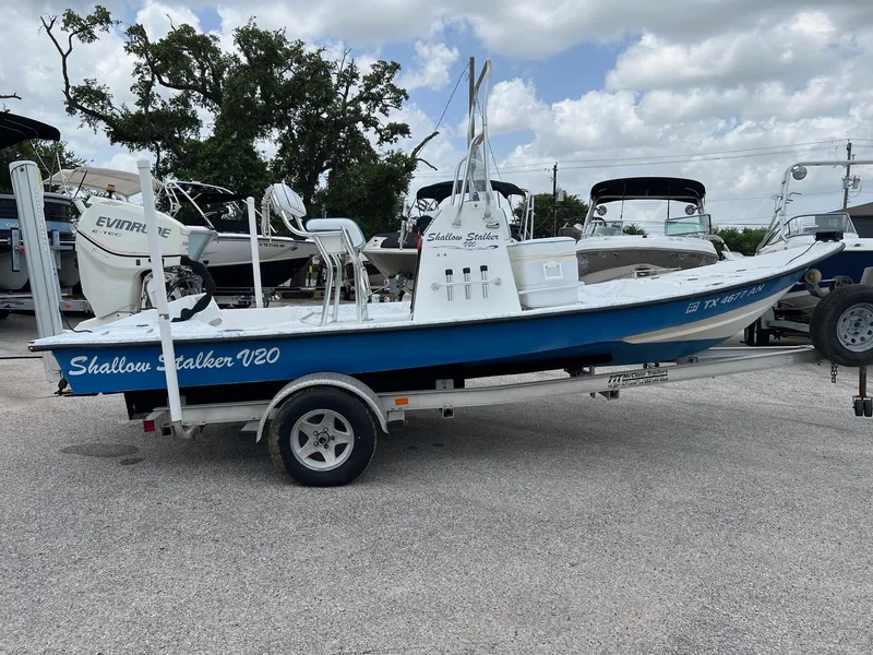 Slide: The Image of 2007 Shallow Stalker V20 boat on trailer, parked outdoors under cloudy sky. - 18