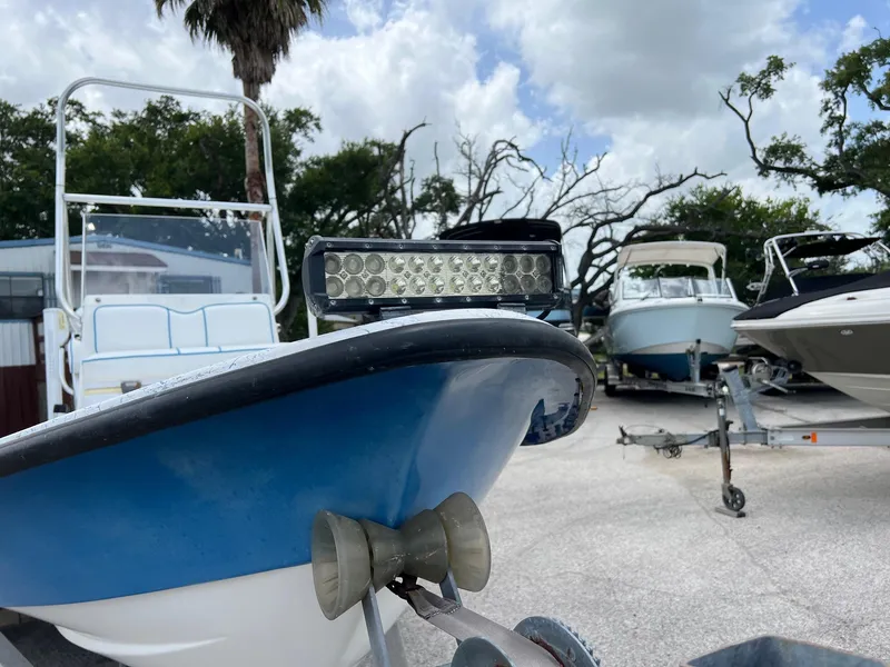Slide: The Image of 2007 Shallow Stalker V20 boat with LED light bar, parked among other boats. - 2