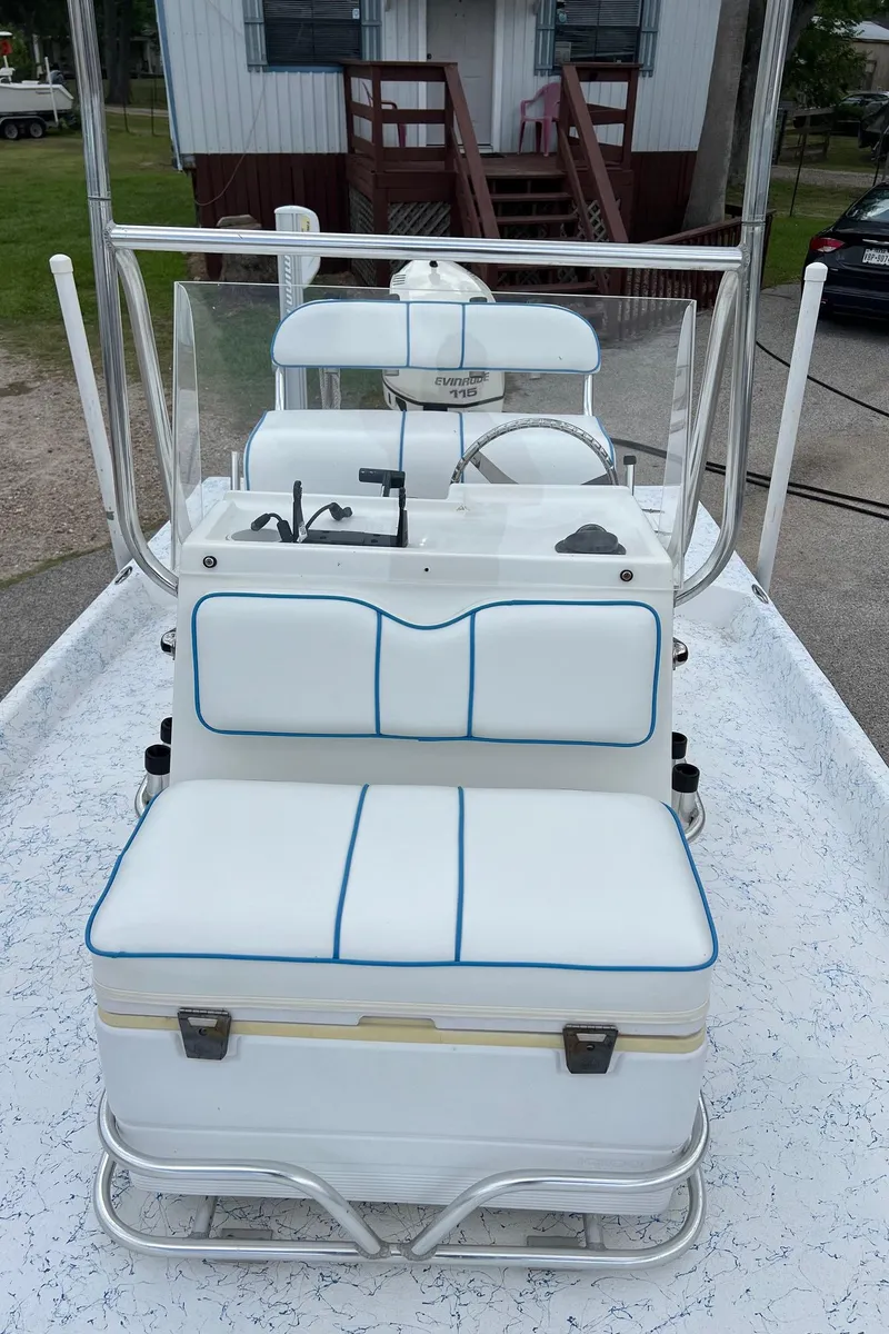 Slide: The Image of 2007 Shallow Stalker V20 boat interior with white seating and steering console. - 21