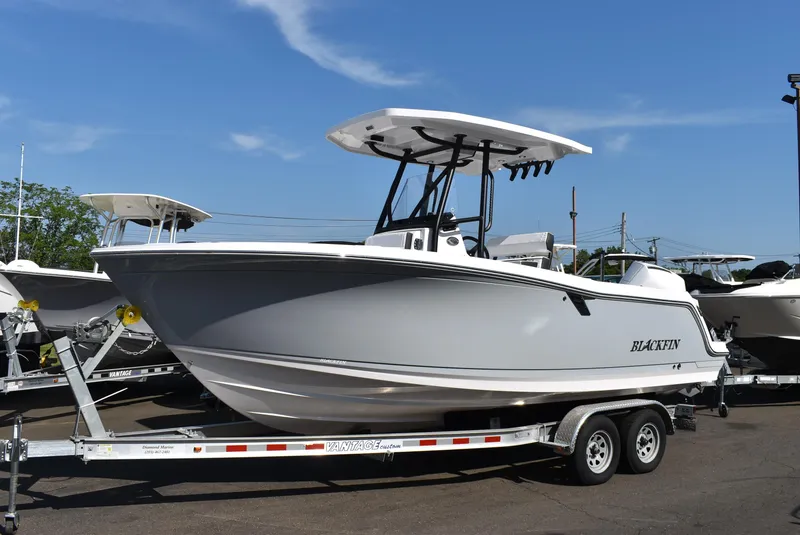 The Image of 2025 Blackfin 222CC boat on trailer under clear blue sky. - 1