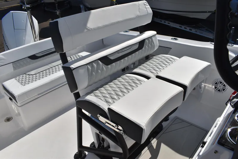 Slide: The Image of 2025 Blackfin 222CC boat interior with white cushioned seating and sleek design. - 12